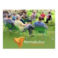 employees of the permaculture institute at a strategy meeting: you see people of different ages and genders sitting on green chairs in a circle on a fresh green meadow. a vegetable garden is indicated in the background and the people in the center of the picture are laughing